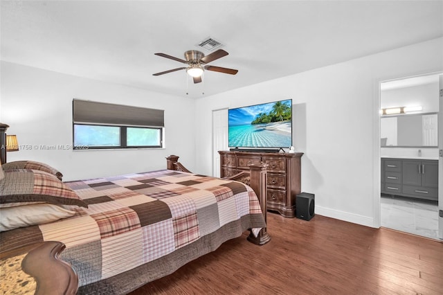 bedroom featuring ensuite bathroom, dark hardwood / wood-style floors, and ceiling fan