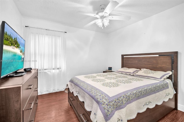 bedroom with dark wood-type flooring and ceiling fan