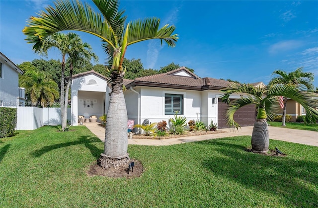 view of front of house featuring a garage and a front lawn