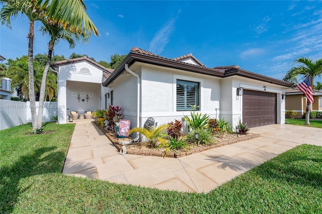 view of front of property featuring a garage and a front yard