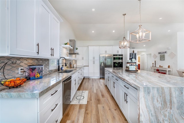 kitchen with backsplash, appliances with stainless steel finishes, hanging light fixtures, and white cabinets