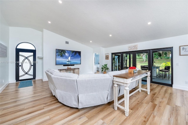 living room with lofted ceiling and light hardwood / wood-style floors