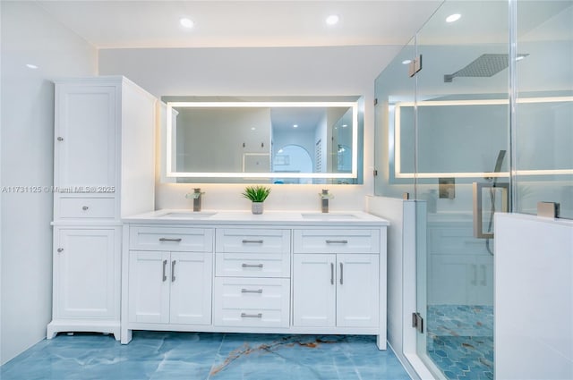 bathroom with a shower stall, a sink, and marble finish floor