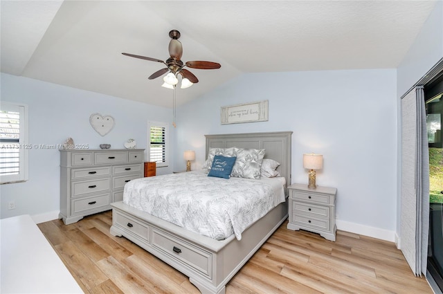 bedroom with a closet, ceiling fan, vaulted ceiling, and light hardwood / wood-style flooring