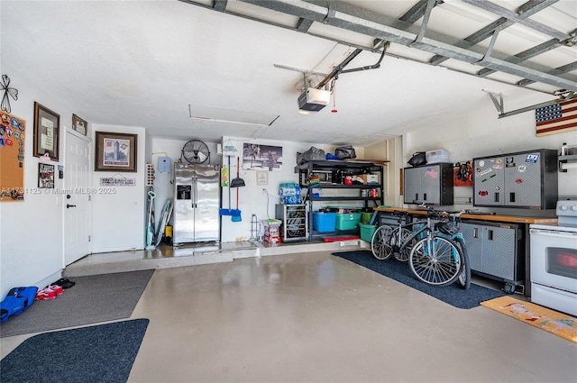 garage with a garage door opener and stainless steel fridge with ice dispenser