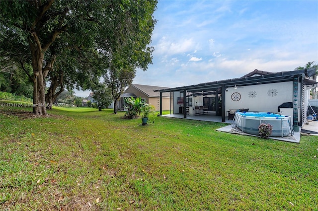 view of yard featuring a patio area and an outdoor pool