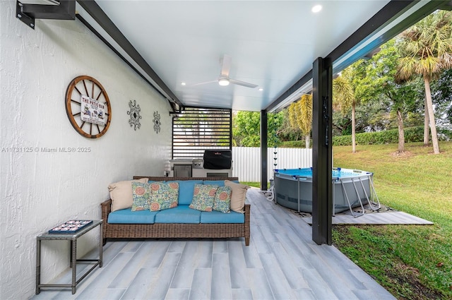 view of patio featuring ceiling fan, a pool, and outdoor lounge area