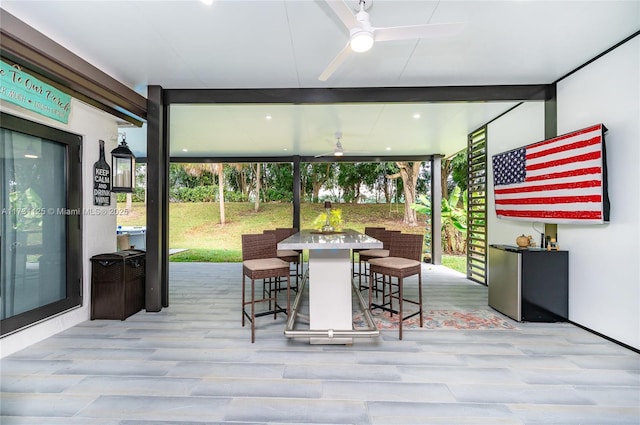interior space with outdoor dining area, a ceiling fan, and a deck