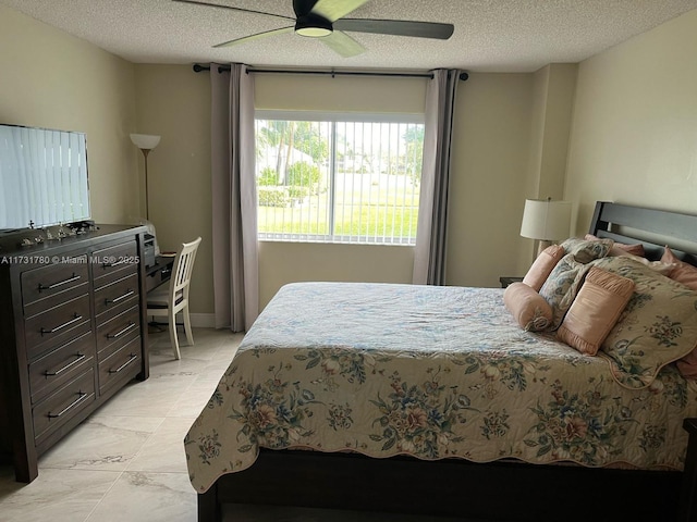 bedroom featuring a textured ceiling and ceiling fan