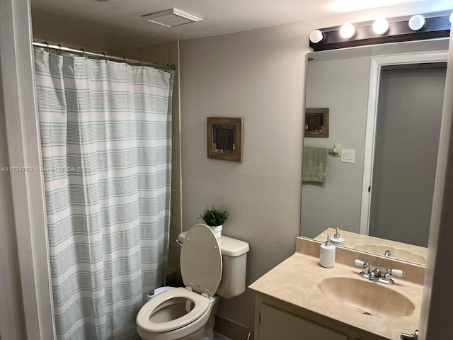 bathroom featuring vanity, a shower with curtain, and toilet