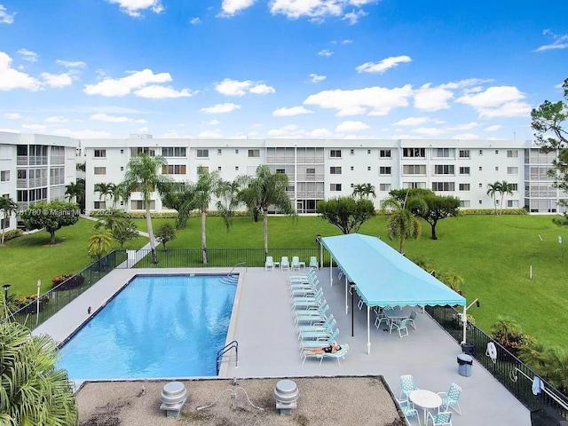 view of swimming pool featuring a patio and a lawn