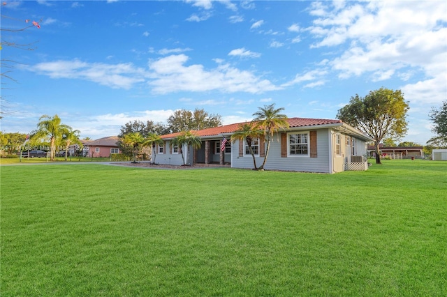 rear view of property with a yard