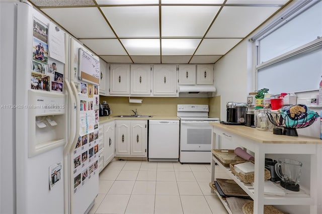 kitchen featuring white cabinetry, light tile patterned floors, white appliances, and a paneled ceiling