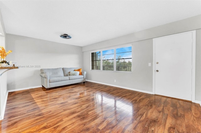 unfurnished living room with wood-type flooring