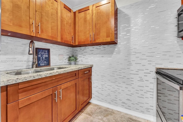 kitchen featuring light tile patterned floors, light stone countertops, sink, and appliances with stainless steel finishes