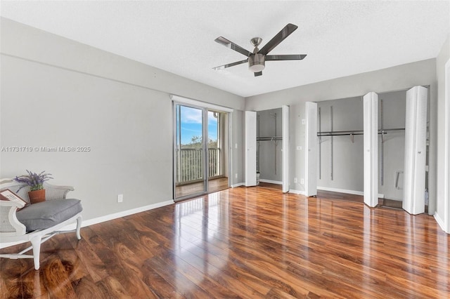 unfurnished bedroom featuring hardwood / wood-style flooring, access to outside, a textured ceiling, and ceiling fan