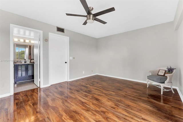 spare room featuring hardwood / wood-style floors and ceiling fan