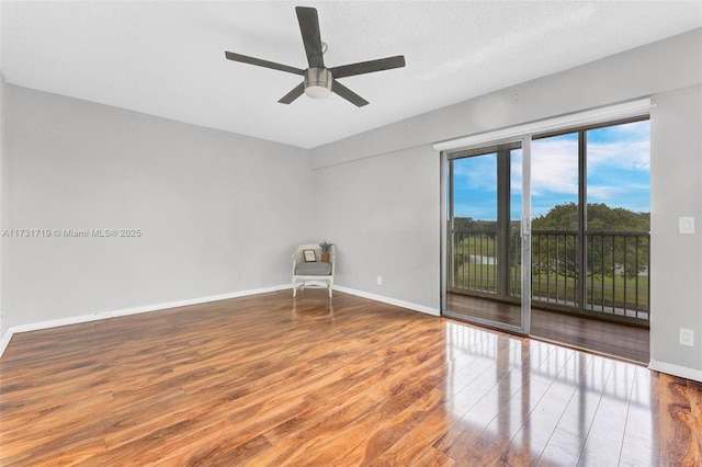 empty room with hardwood / wood-style flooring, ceiling fan, and a textured ceiling