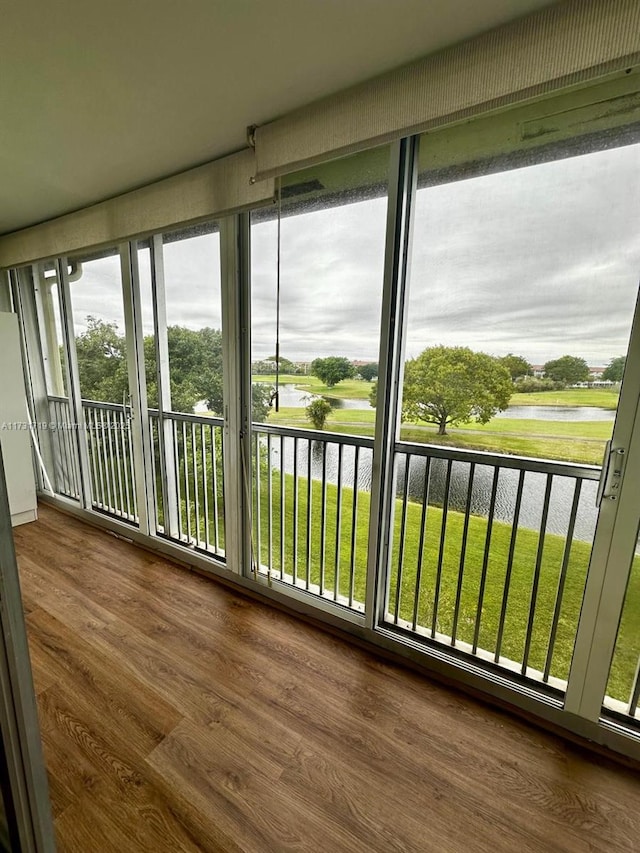 unfurnished sunroom featuring plenty of natural light and a water view