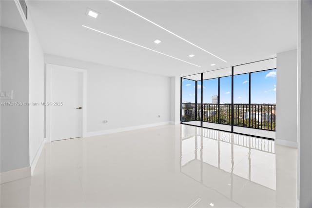 unfurnished room with expansive windows