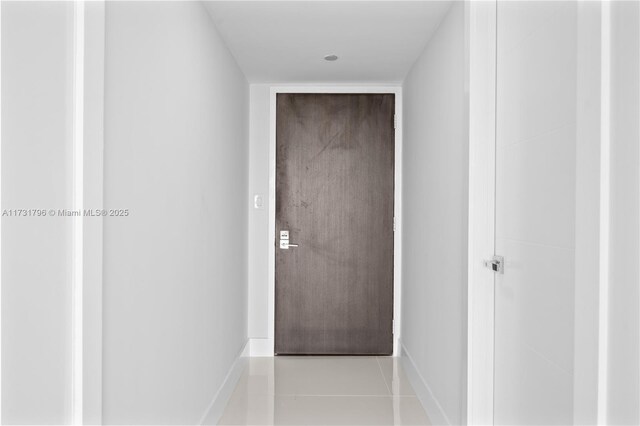 hallway with tile patterned floors