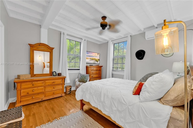 bedroom with hardwood / wood-style flooring, ceiling fan, and beam ceiling