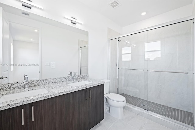 bathroom with walk in shower, vanity, toilet, and tile patterned flooring