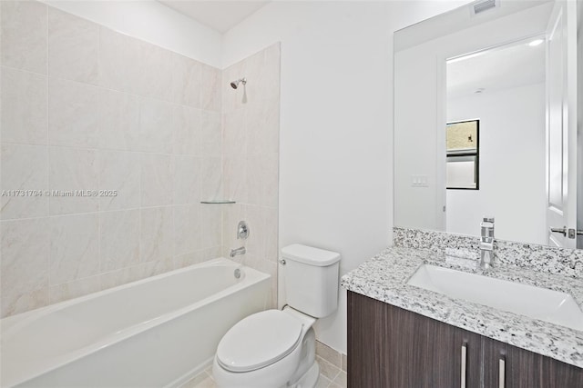 full bathroom with tiled shower / bath combo, vanity, and toilet