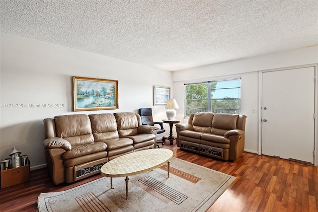 living room with a textured ceiling and dark hardwood / wood-style flooring