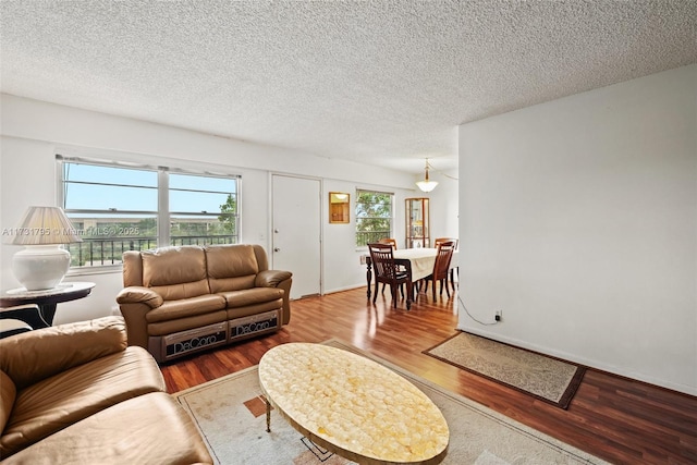 living room featuring hardwood / wood-style flooring, a wealth of natural light, and a textured ceiling