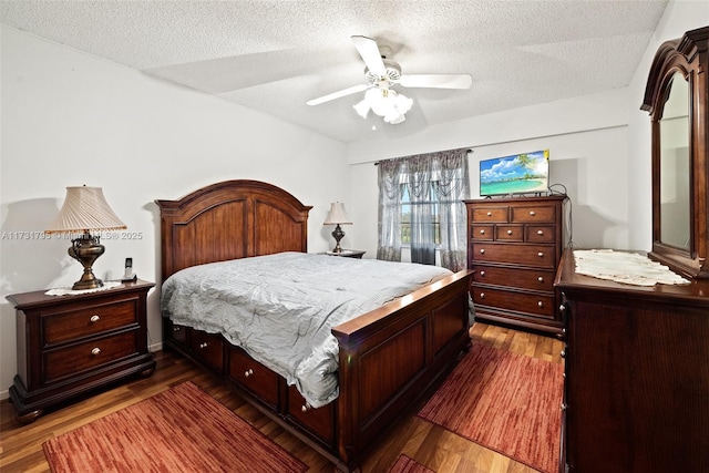 bedroom with dark hardwood / wood-style floors, a textured ceiling, and ceiling fan