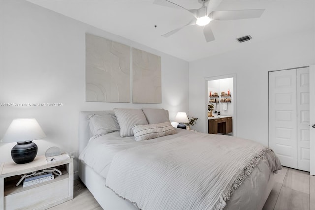 bedroom featuring ceiling fan and ensuite bathroom