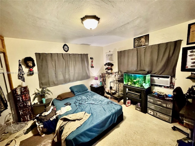 bedroom with an AC wall unit and a textured ceiling