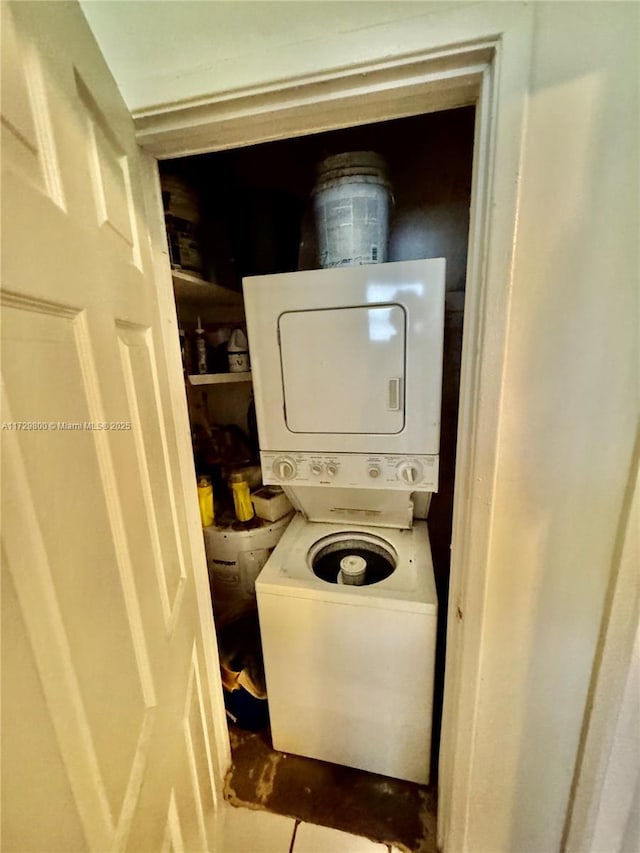 laundry room featuring stacked washer / drying machine