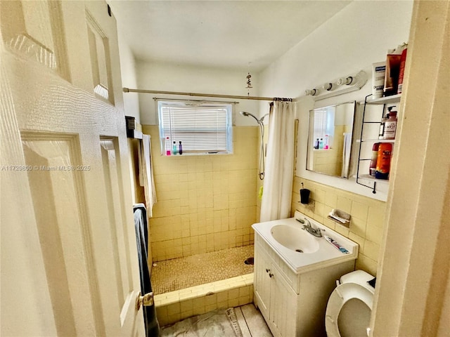 bathroom with tile walls, a shower with shower curtain, vanity, decorative backsplash, and toilet