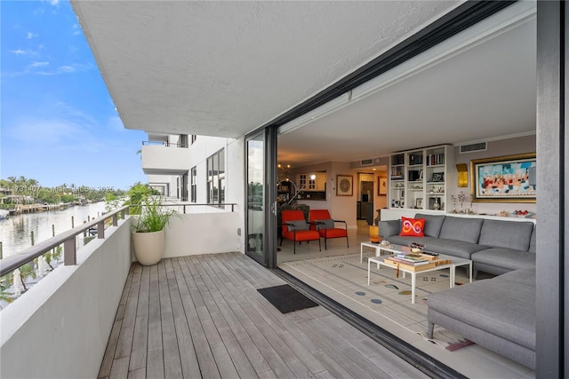 balcony with a water view and outdoor lounge area