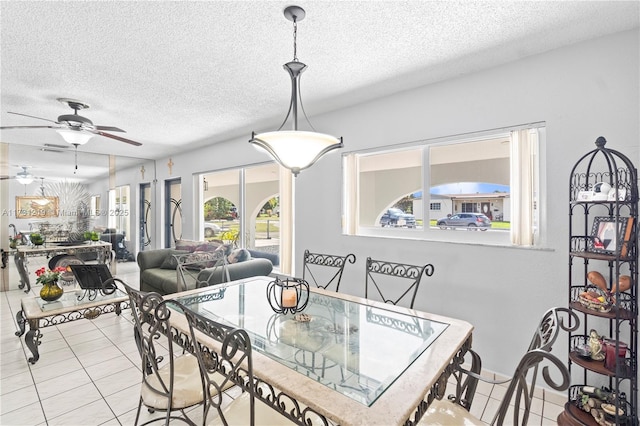 dining space featuring ceiling fan, a textured ceiling, and light tile patterned floors