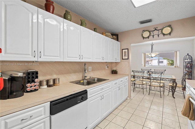 kitchen with sink, dishwasher, white cabinetry, hanging light fixtures, and a textured ceiling