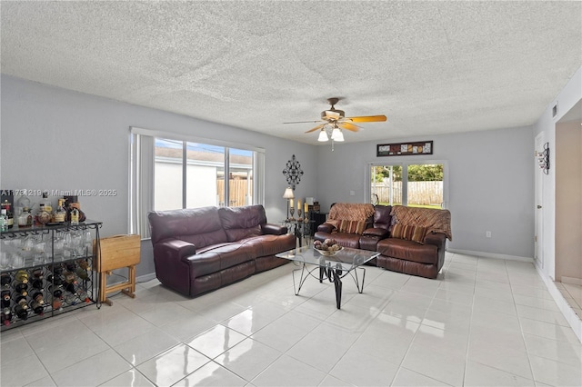 tiled living room featuring ceiling fan