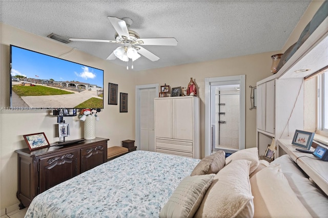 bedroom featuring a textured ceiling, ceiling fan, and ensuite bathroom