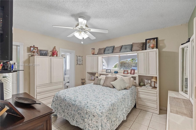 bedroom featuring a textured ceiling, ceiling fan, and light tile patterned flooring