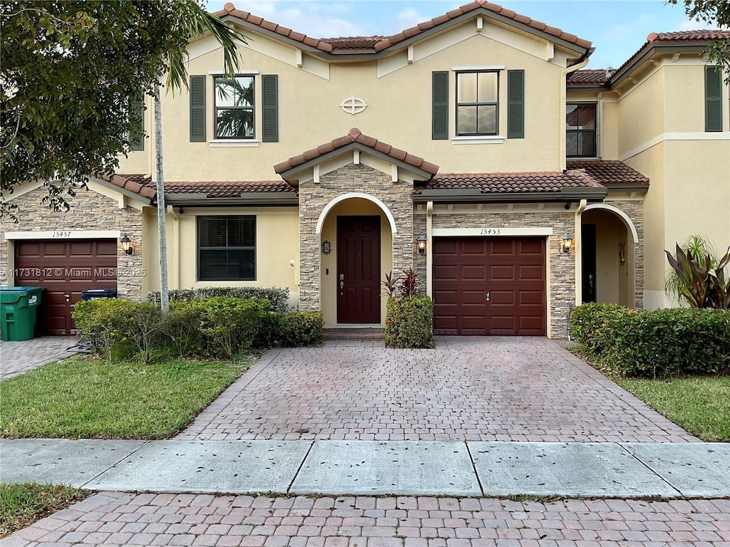 mediterranean / spanish-style house with a garage