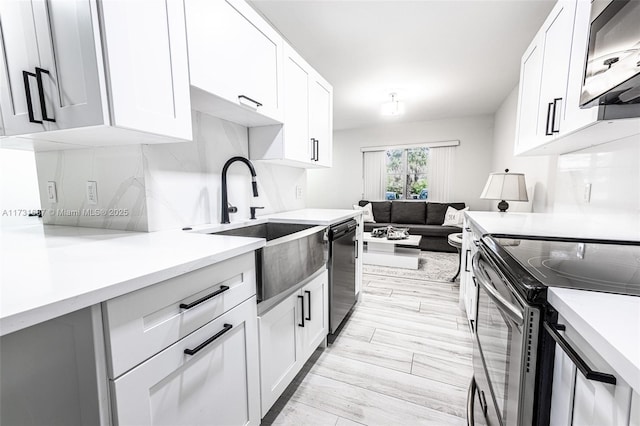 kitchen featuring white cabinetry, sink, and stainless steel appliances