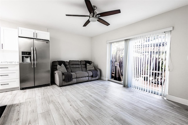 living room featuring ceiling fan and light hardwood / wood-style flooring