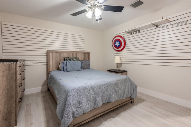 bedroom with ceiling fan and light hardwood / wood-style flooring