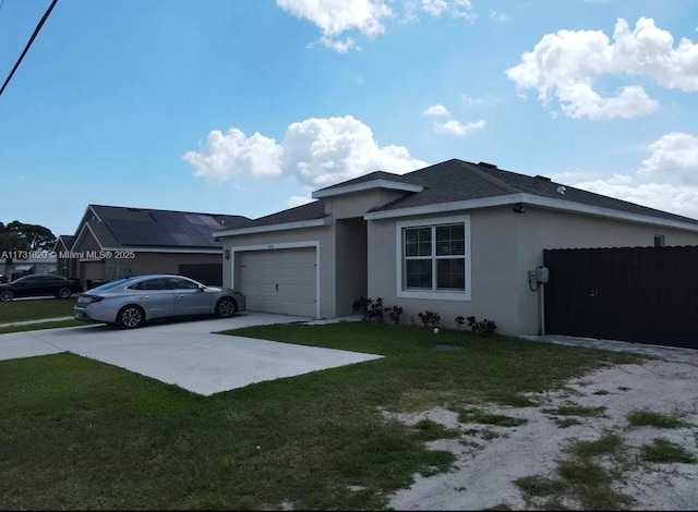 view of front of house featuring a garage and a front lawn