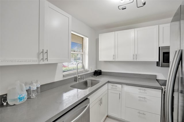 kitchen featuring white cabinetry, appliances with stainless steel finishes, and sink