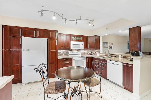 kitchen with sink, light tile patterned floors, white appliances, and decorative backsplash