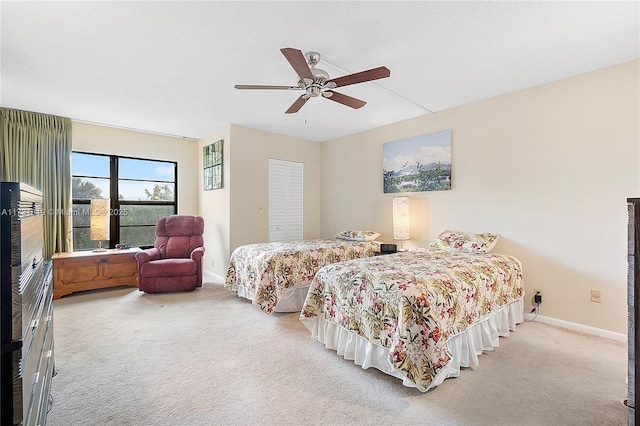 bedroom featuring a closet, ceiling fan, and carpet