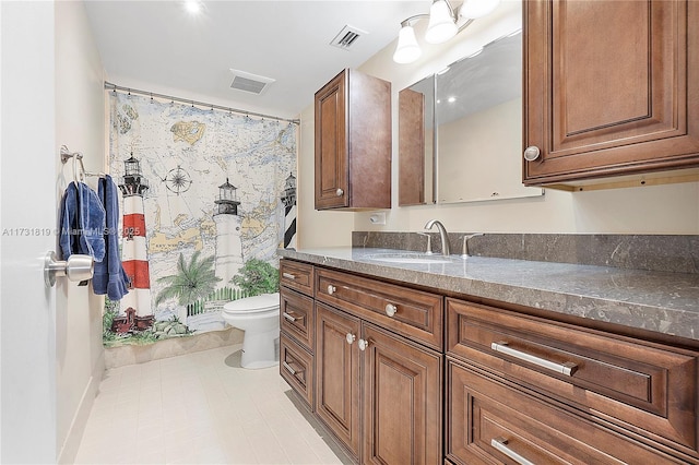 bathroom featuring vanity, toilet, and walk in shower